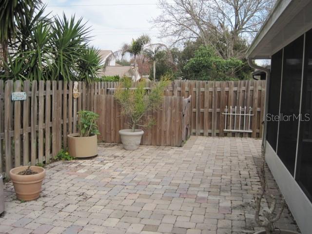 5415 Rutland Court Orlando, FL 32812 - Photo 20 of 25 a view of a backyard with potted plants and wooden fence