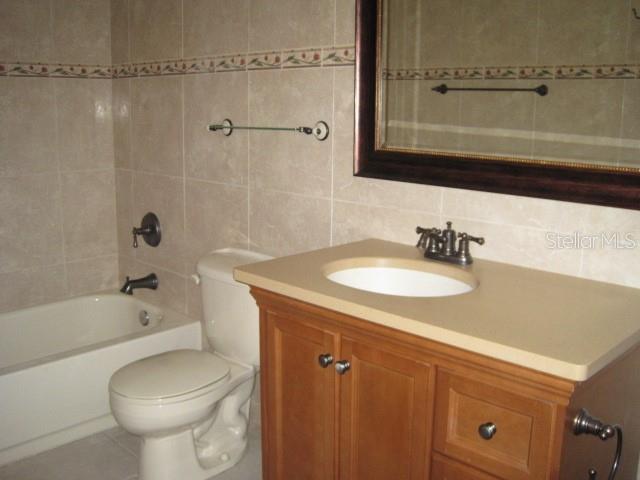 5415 Rutland Court Orlando, FL 32812 - Photo 10 of 25 a bathroom with a sink a toilet and shower