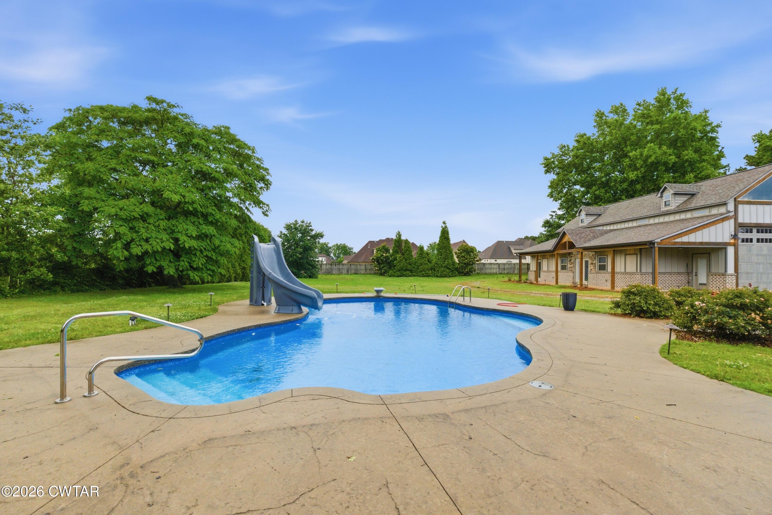 963 Ashport Road Jackson, TN 38305 - Photo 58 of 60 a view of a house with swimming pool and yard