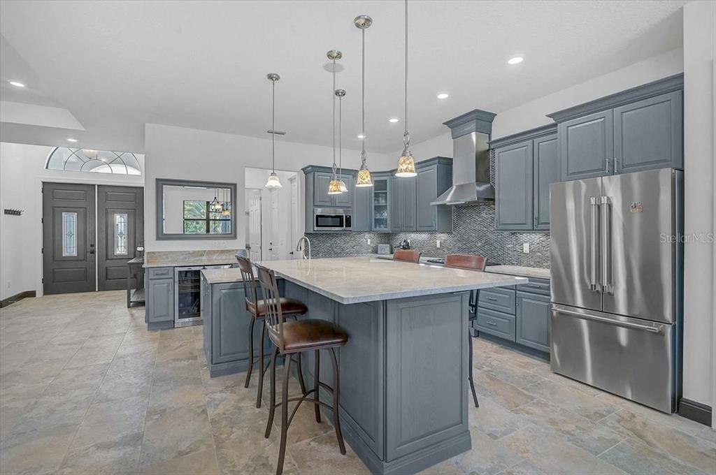 113 Burney Road Osprey, FL 34229 - Photo 11 of 42 a kitchen with stainless steel appliances granite countertop a refrigerator a sink a stove and a cabinets