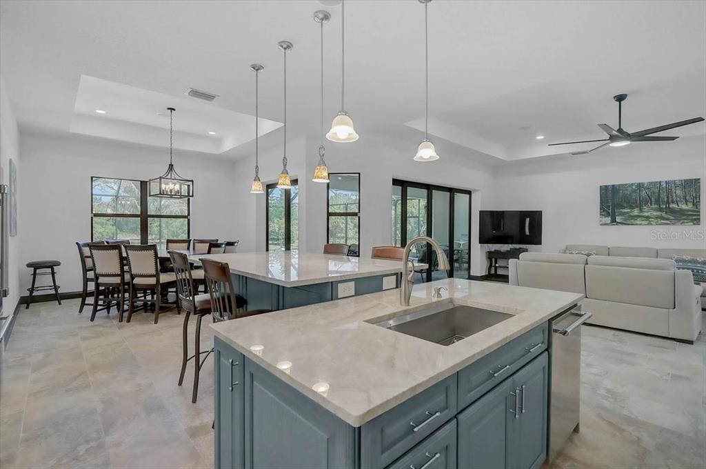 113 Burney Road Osprey, FL 34229 - Photo 13 of 42 a kitchen with granite countertop a sink a counter top space appliances and cabinets