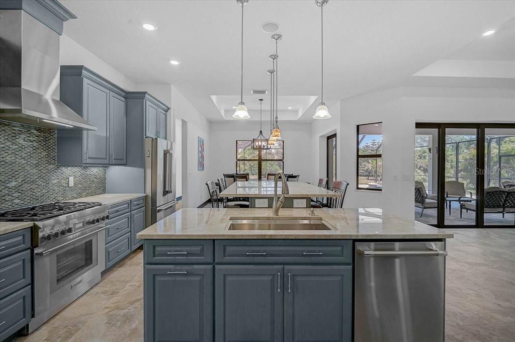 113 Burney Road Osprey, FL 34229 - Photo 14 of 42 a kitchen with kitchen island granite countertop a sink cabinets and stainless steel appliances