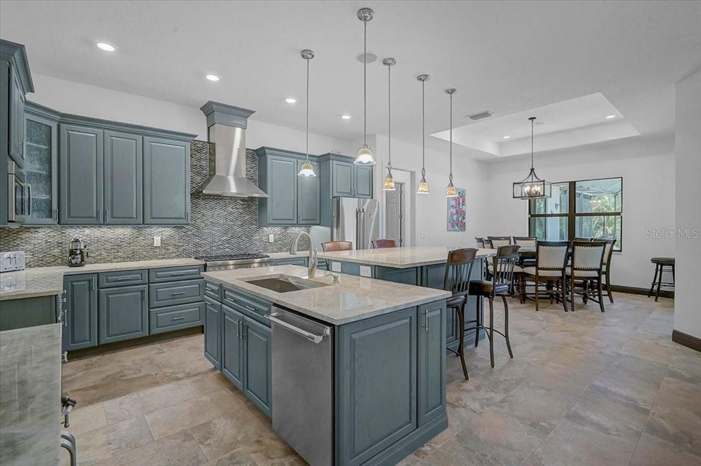 113 Burney Road Osprey, FL 34229 - Photo 15 of 42 a kitchen with sink cabinets and dining table