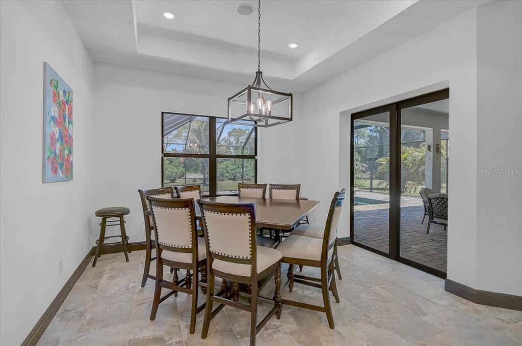 113 Burney Road Osprey, FL 34229 - Photo 16 of 42 a dining room with furniture a chandelier and window