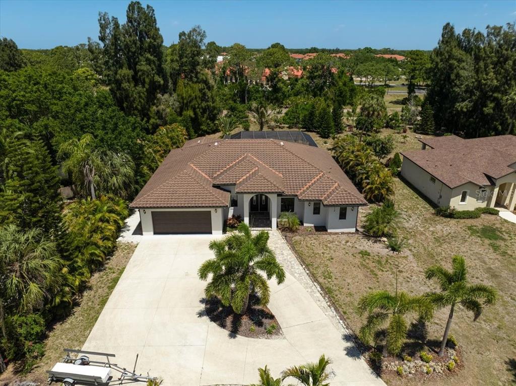 113 Burney Road Osprey, FL 34229 - Photo 2 of 42 an aerial view of a house with yard and green space
