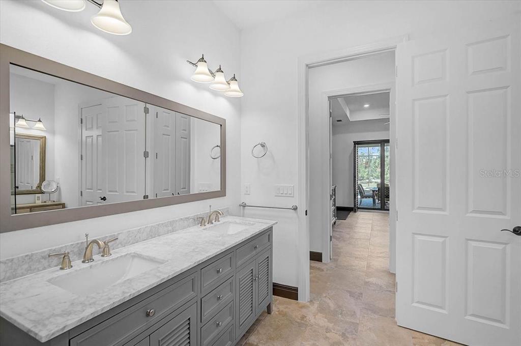 113 Burney Road Osprey, FL 34229 - Photo 22 of 42 a spacious bathroom with a granite countertop sink mirror and vanity