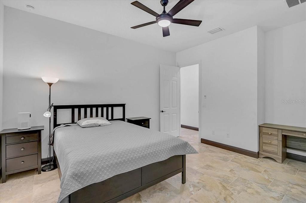 113 Burney Road Osprey, FL 34229 - Photo 25 of 42 a bedroom with a bed and a cabinets