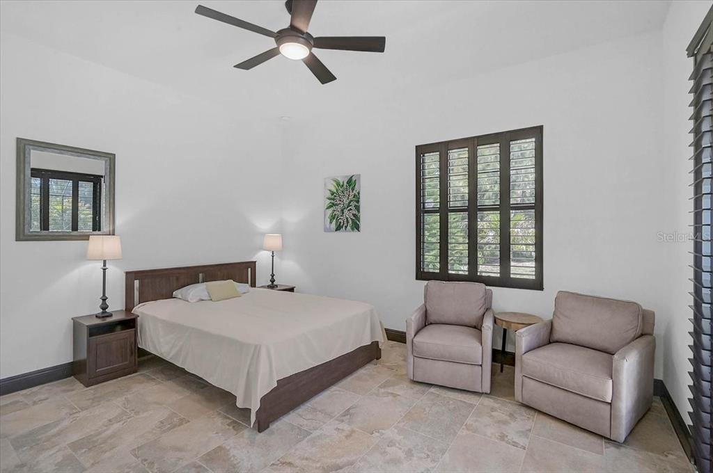 113 Burney Road Osprey, FL 34229 - Photo 27 of 42 a bedroom with a bed couch and window
