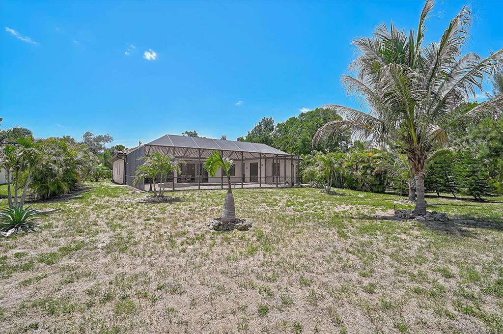 113 Burney Road Osprey, FL 34229 - Photo 36 of 42 a front view of a house with a yard