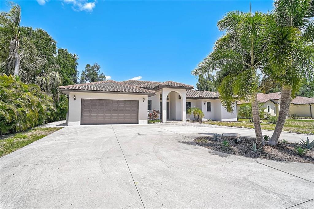 113 Burney Road Osprey, FL 34229 - Photo 41 of 42 a front view of a house with garden
