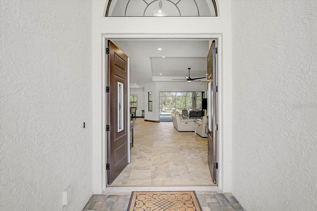 113 Burney Road Osprey, FL 34229 - Photo 6 of 42 a view of a hallway with a livingroom and a livingroom with furniture