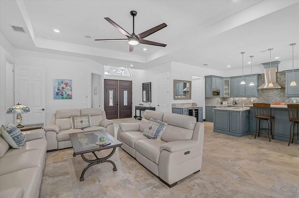 113 Burney Road Osprey, FL 34229 - Photo 9 of 42 a living room with furniture kitchen view and a chandelier