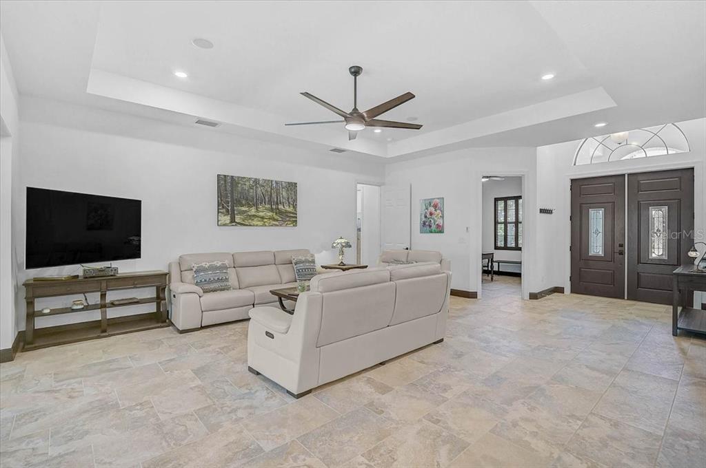 113 Burney Road Osprey, FL 34229 - Photo 10 of 42 a living room with furniture and a flat screen tv