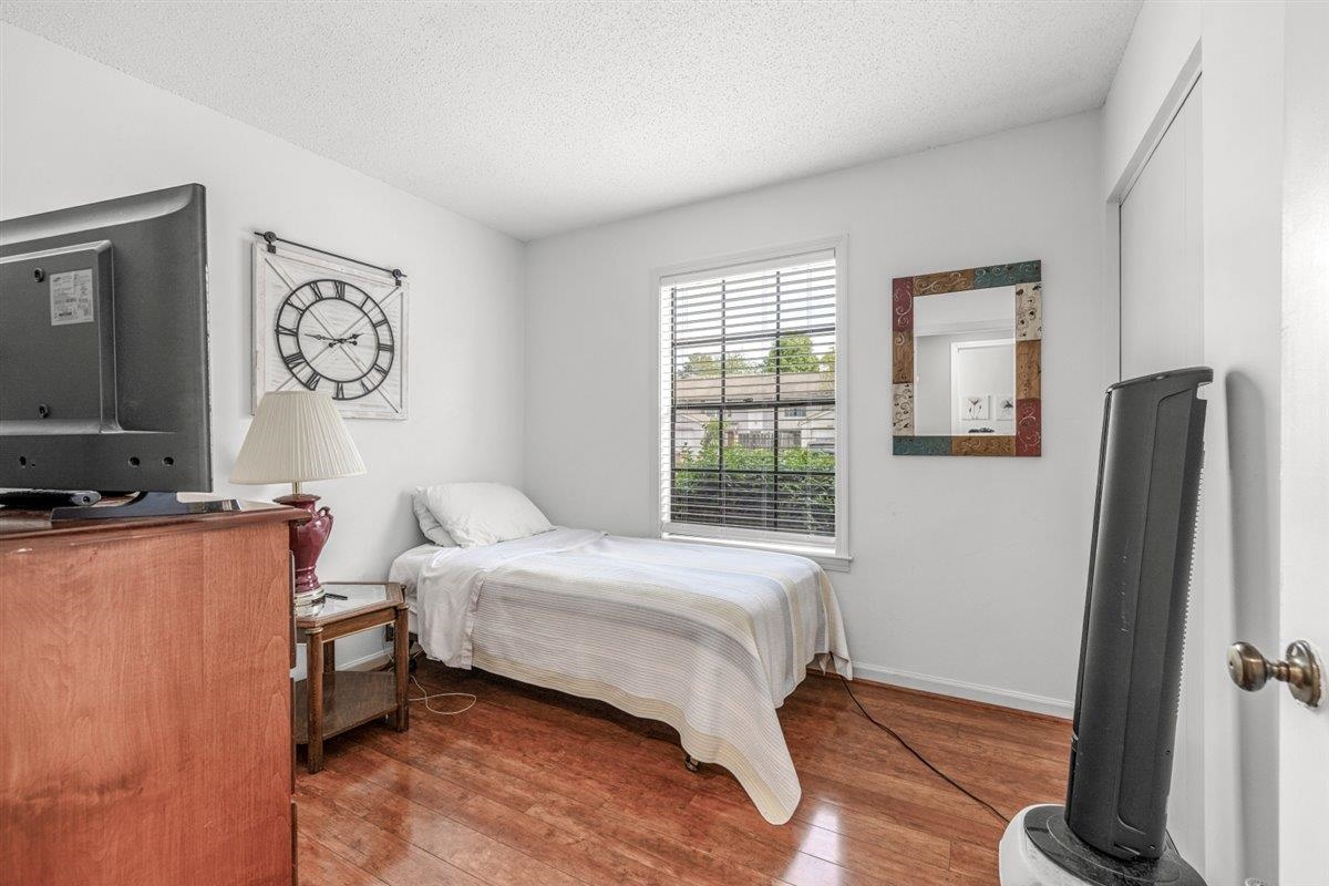 2976 Kin Cove, Unit 2976 Memphis, TN 38119 - Photo 13 of 24 Bedroom featuring wood-finish flooring, white walls, and a window with horizontal blinds