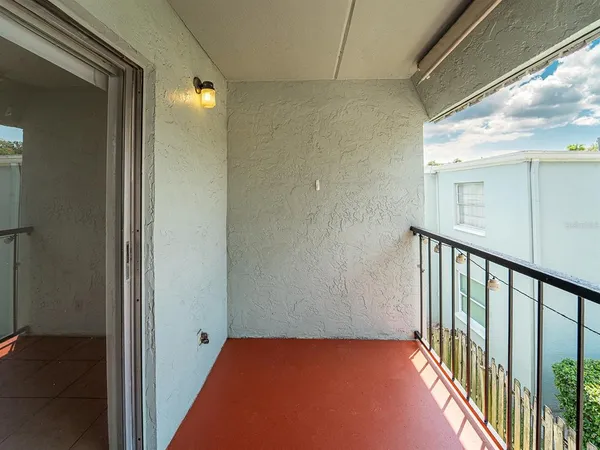 a view of hallway with a large window and wooden floor