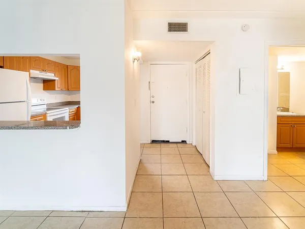 a view of a kitchen from the hallway