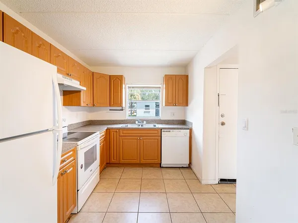 a kitchen with stainless steel appliances granite countertop a sink and a stove