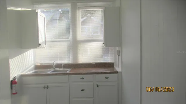 a bathroom with a granite countertop sink and a window