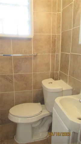 a white toilet sitting next to a white sink