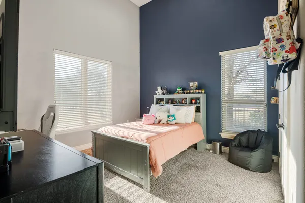 a bedroom with a bed and a table