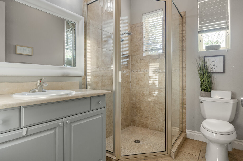 22226 Rivolta Lane San Antonio, TX 78257 - Photo 14 of 24 a bathroom with a sink toilet and shower