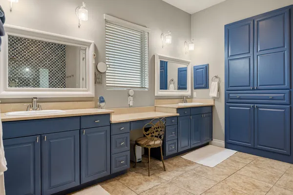 a spacious bathroom with a sink and a large mirror