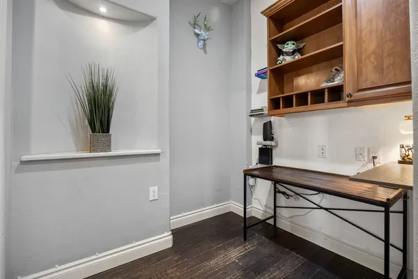 a view of cabinets with wooden floor and a potted plant