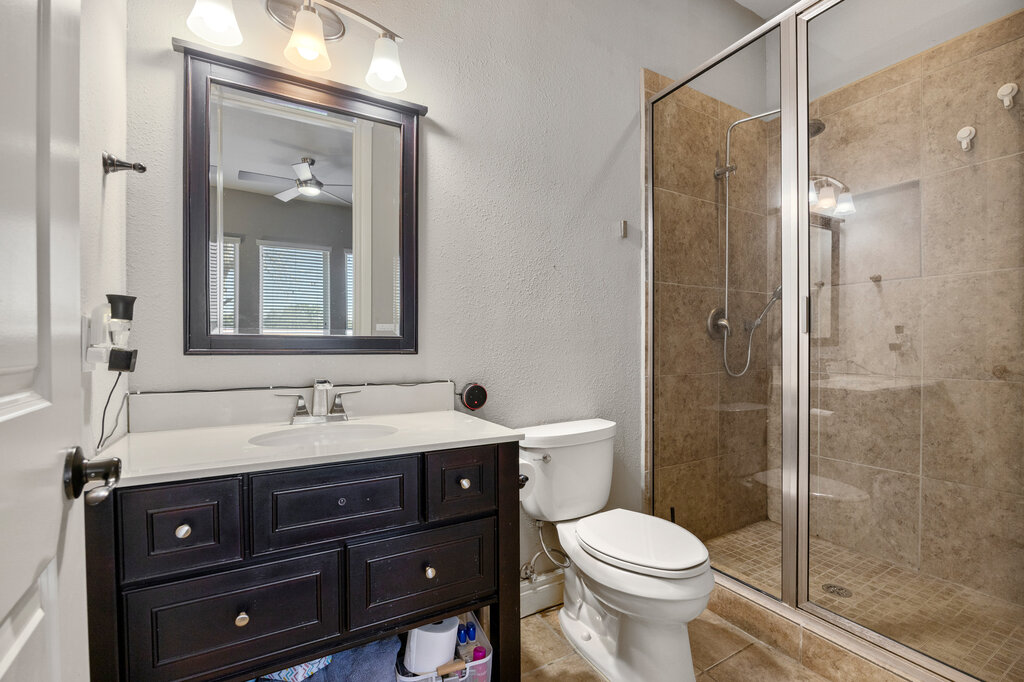 22226 Rivolta Lane San Antonio, TX 78257 - Photo 22 of 24 a bathroom with a toilet sink and mirror