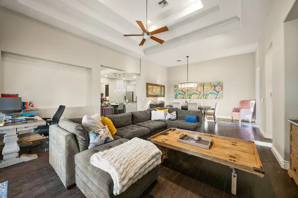 a living room with furniture and a ceiling fan