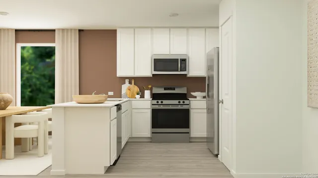 a kitchen with stainless steel appliances a stove sink and microwave