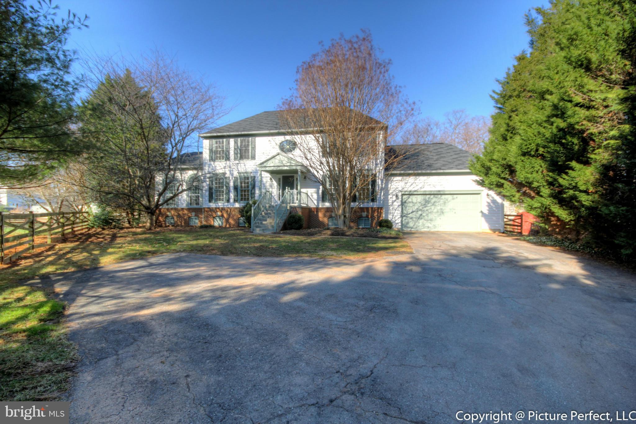 19111 Munger Farm Road Poolesville, MD 20837 - Photo 2 of 30 a view of a house with backyard and trees
