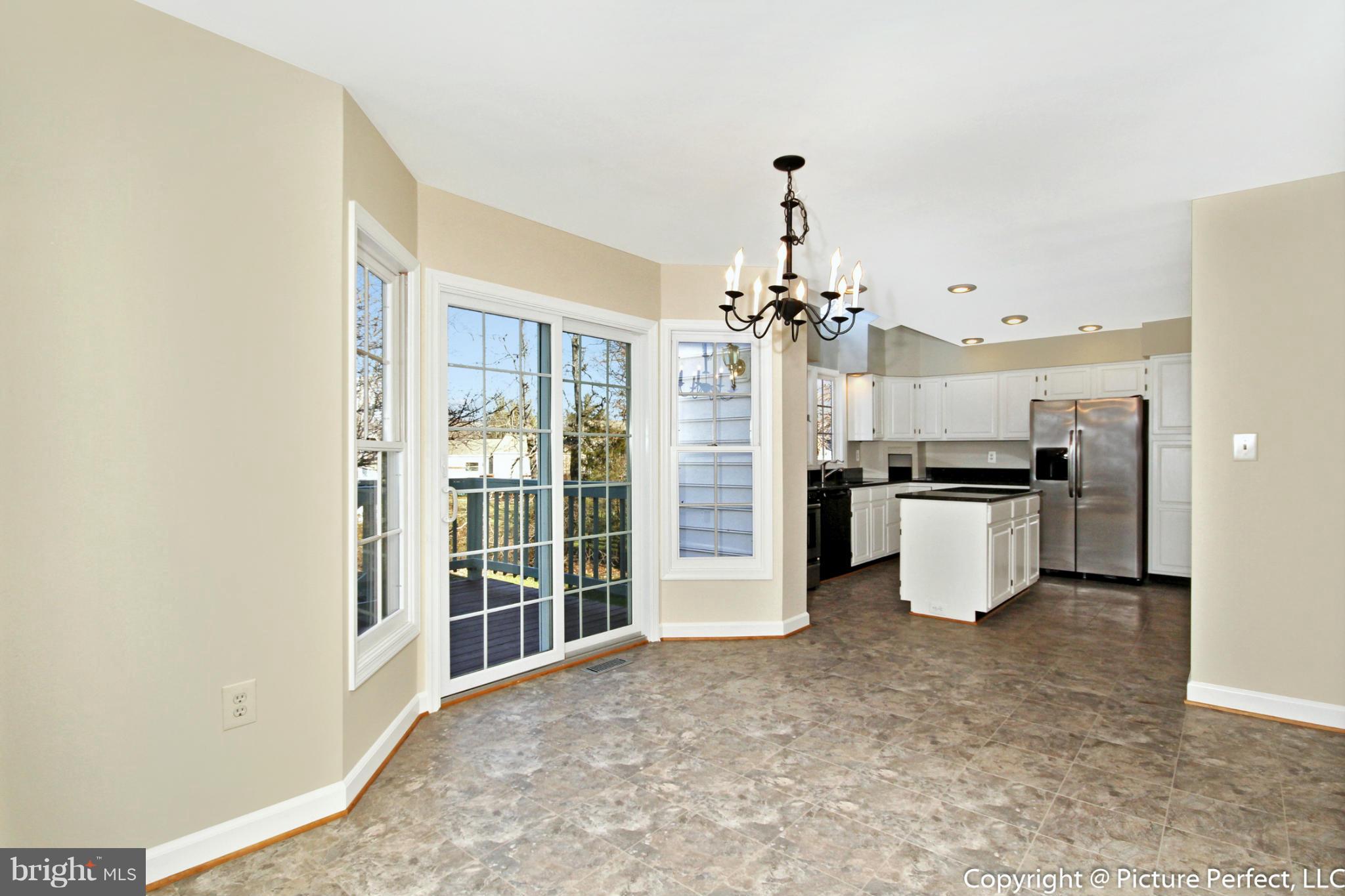 19111 Munger Farm Road Poolesville, MD 20837 - Photo 14 of 30 a view of a kitchen with refrigerator and windows