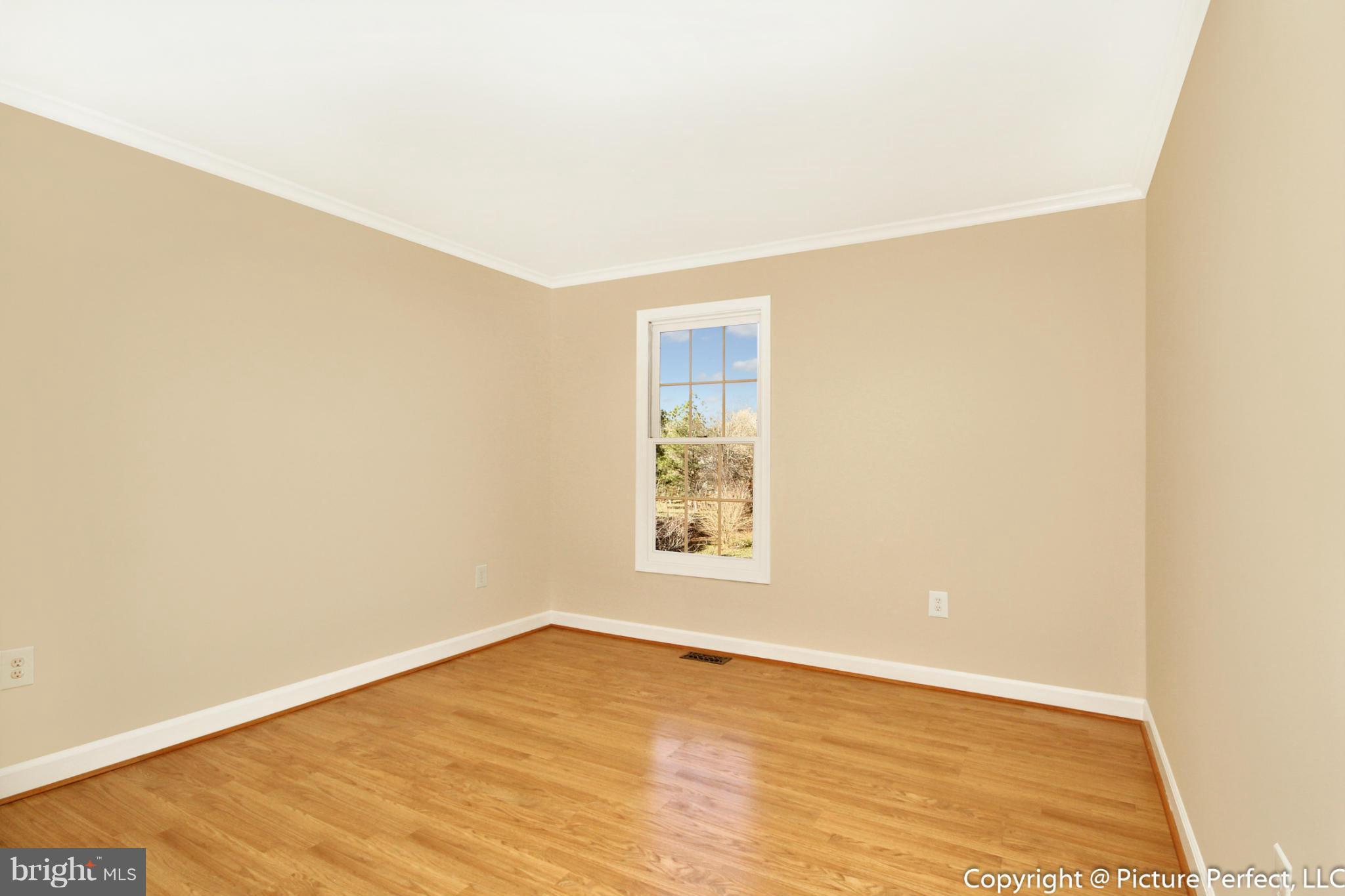 19111 Munger Farm Road Poolesville, MD 20837 - Photo 24 of 30 a view of an empty room with wooden floor and a window