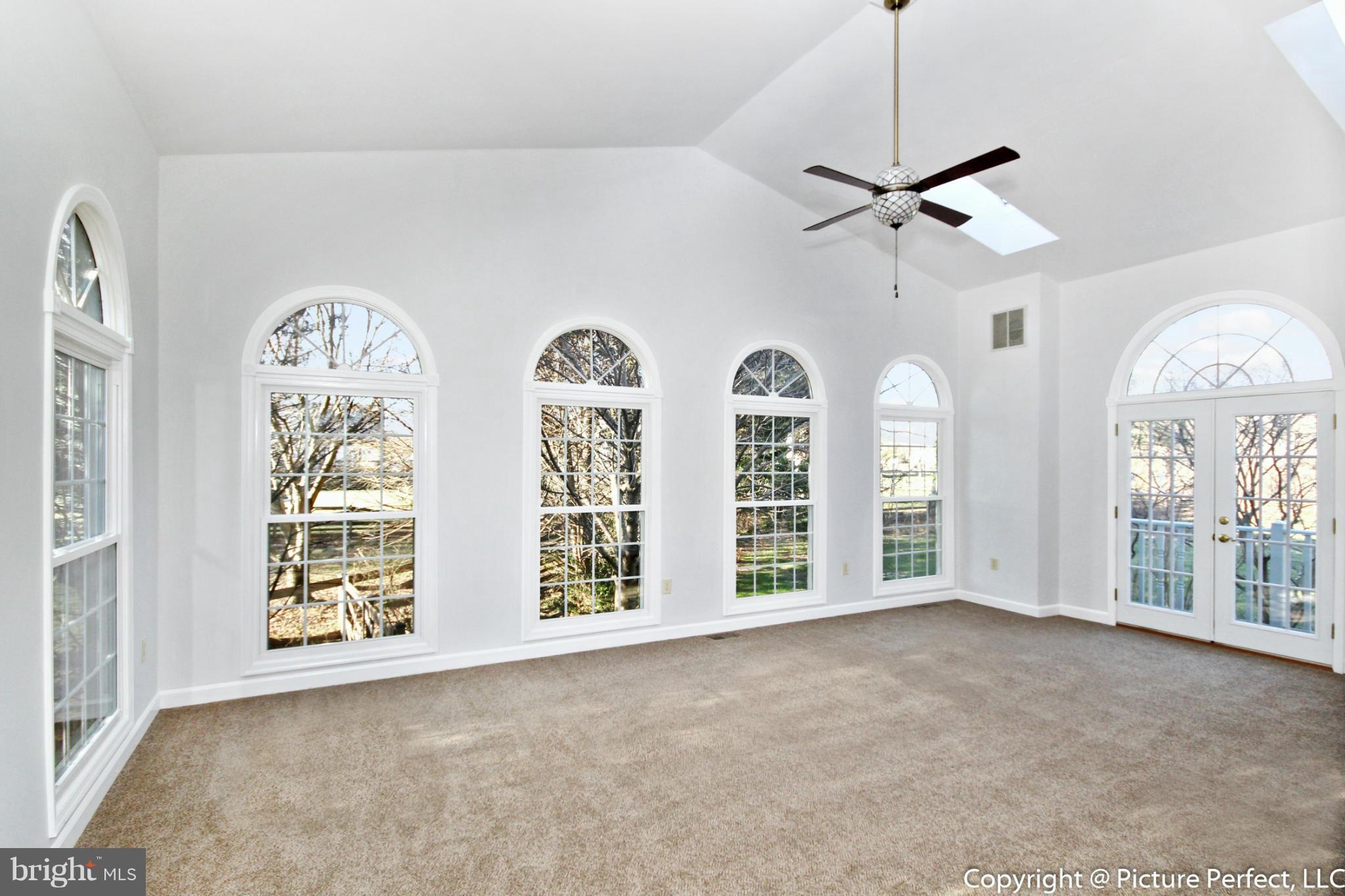 19111 Munger Farm Road Poolesville, MD 20837 - Photo 10 of 30 a view of an empty room with windows and chandelier