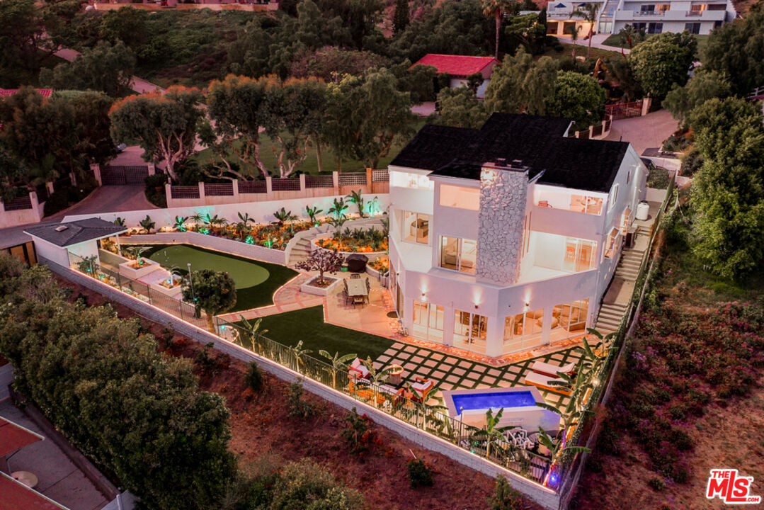 an aerial view of a house with outdoor space