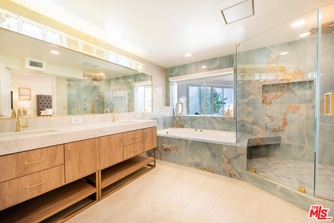 31271 Bailard Road Malibu, CA 90265 - Photo 17 of 38 a bathroom with a double vanity sink and a large mirror