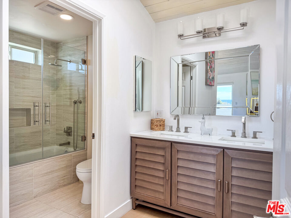 31271 Bailard Road Malibu, CA 90265 - Photo 21 of 38 a bathroom with a double vanity sink mirror and shower