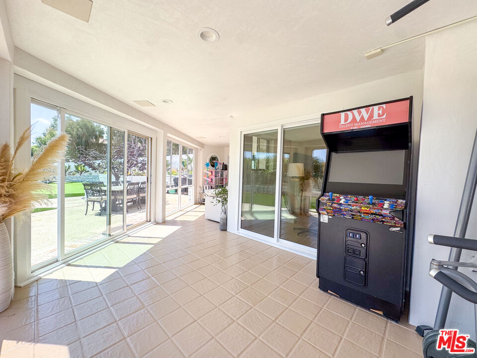 31271 Bailard Road Malibu, CA 90265 - Photo 29 of 38 a living room with furniture a flat screen tv and a floor to ceiling window