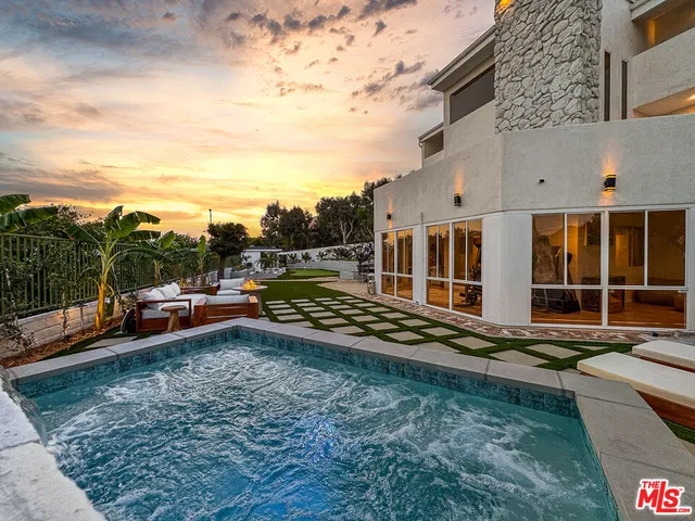 a view of a house with backyard sitting area and tub