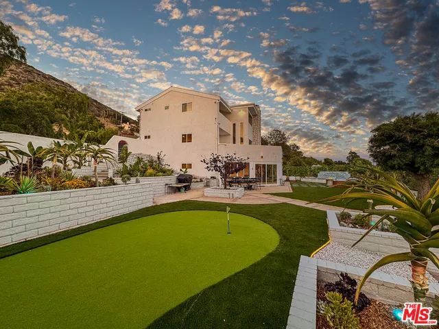 a view of swimming pool with outdoor seating and plants