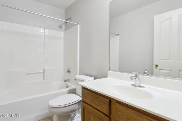 a bathroom with a sink toilet vanity and shower