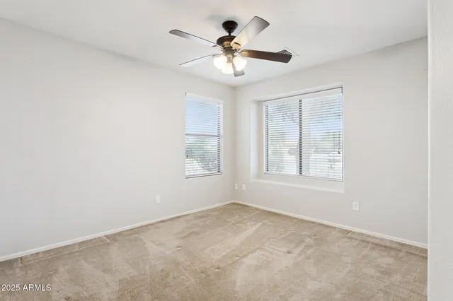 a view of a livingroom with a ceiling fan and window