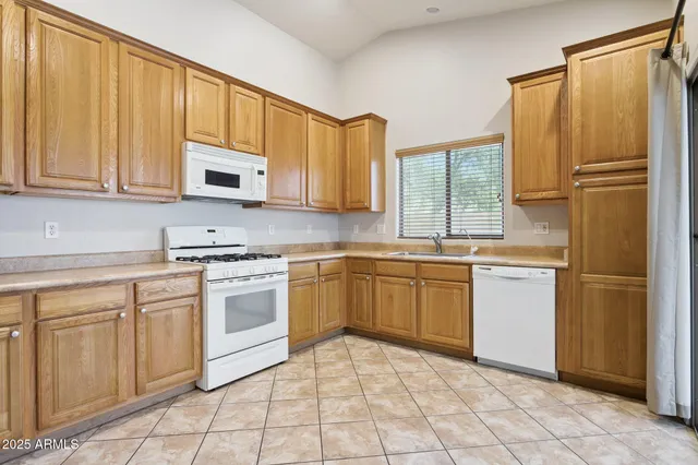 a kitchen with a stove top oven sink and cabinets