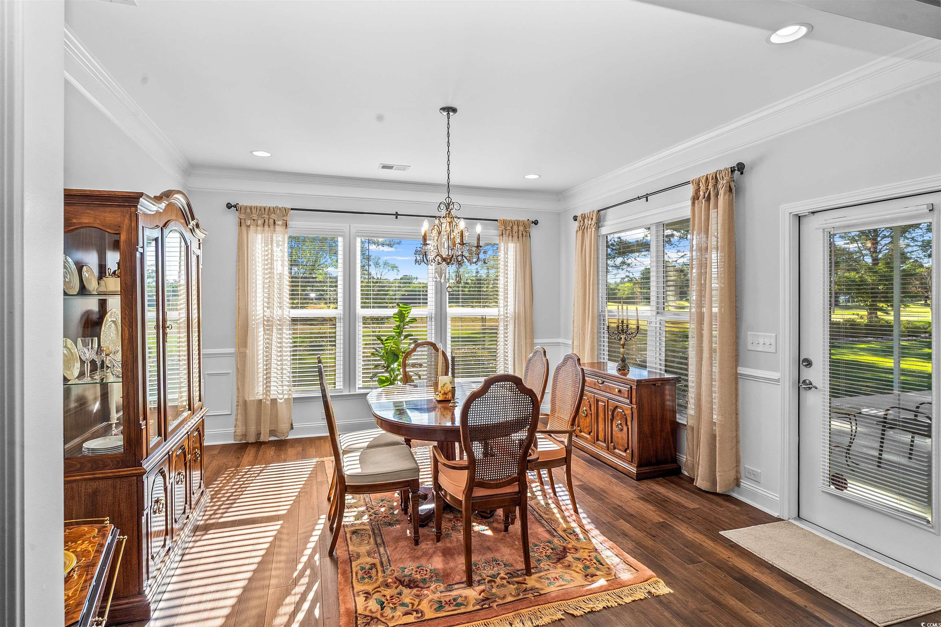 9169 Oldfield Road Calabash, NC 28467 - Photo 19 of 39 Dining room featuring ornamental molding, visible vents, recessed lighting, dark wood finished floors, and an inviting chandelier