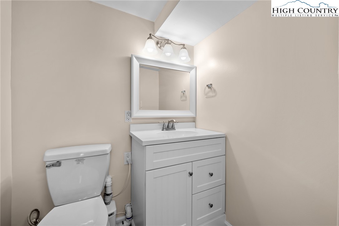 17 Elderberry Loop Newland, NC 28657 - Photo 33 of 47 a bathroom with a toilet sink vanity and mirror