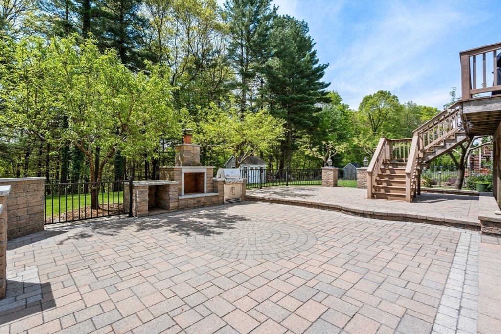 34 Hound Pack Circle Walpole, MA 02032 - Photo 30 of 40 a view of a yard with plants and a bench