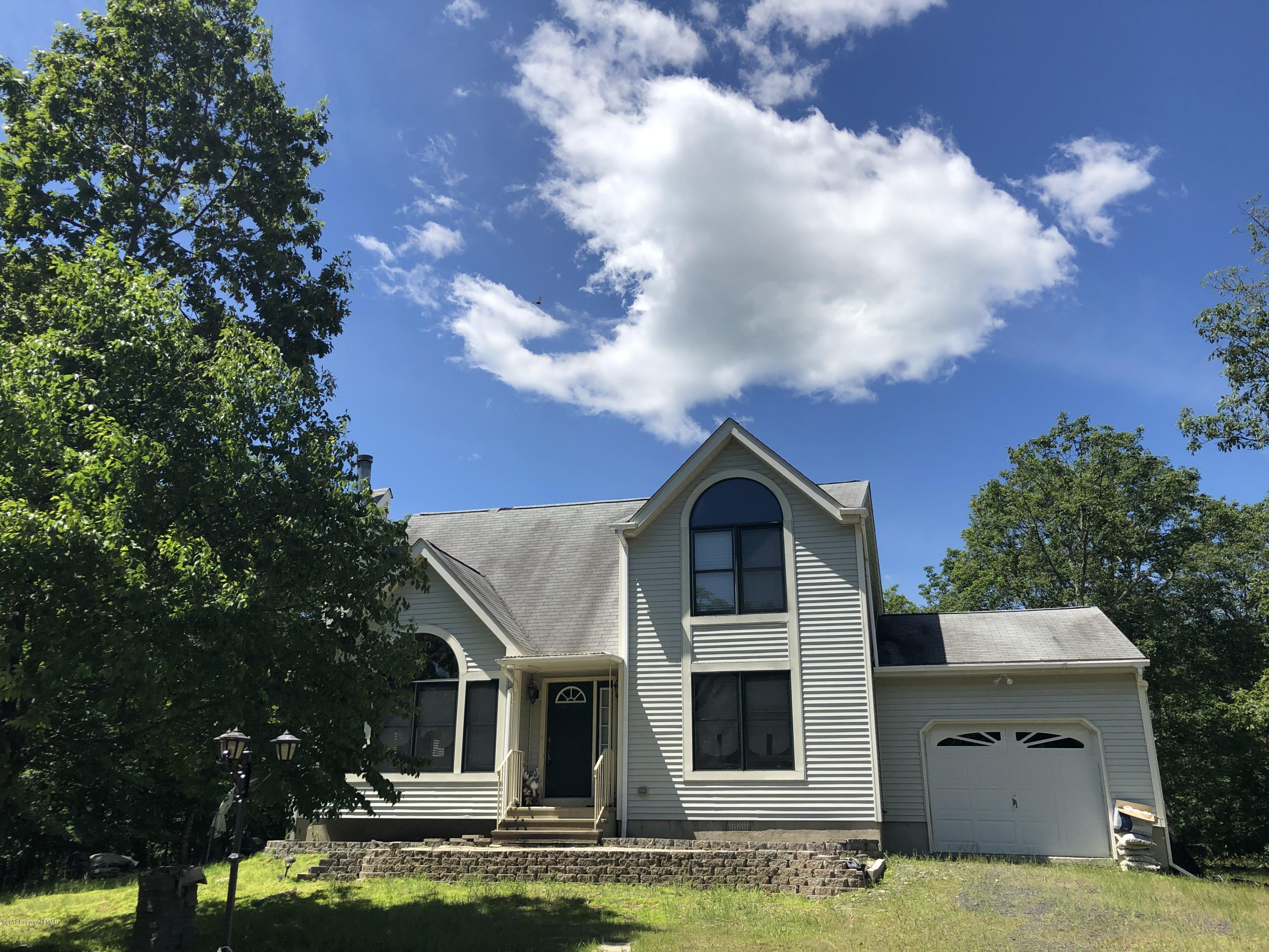 189 Gold Finch Road Bushkill, PA 18324 - Photo 3 of 23 a front view of house with yard and trees in the background