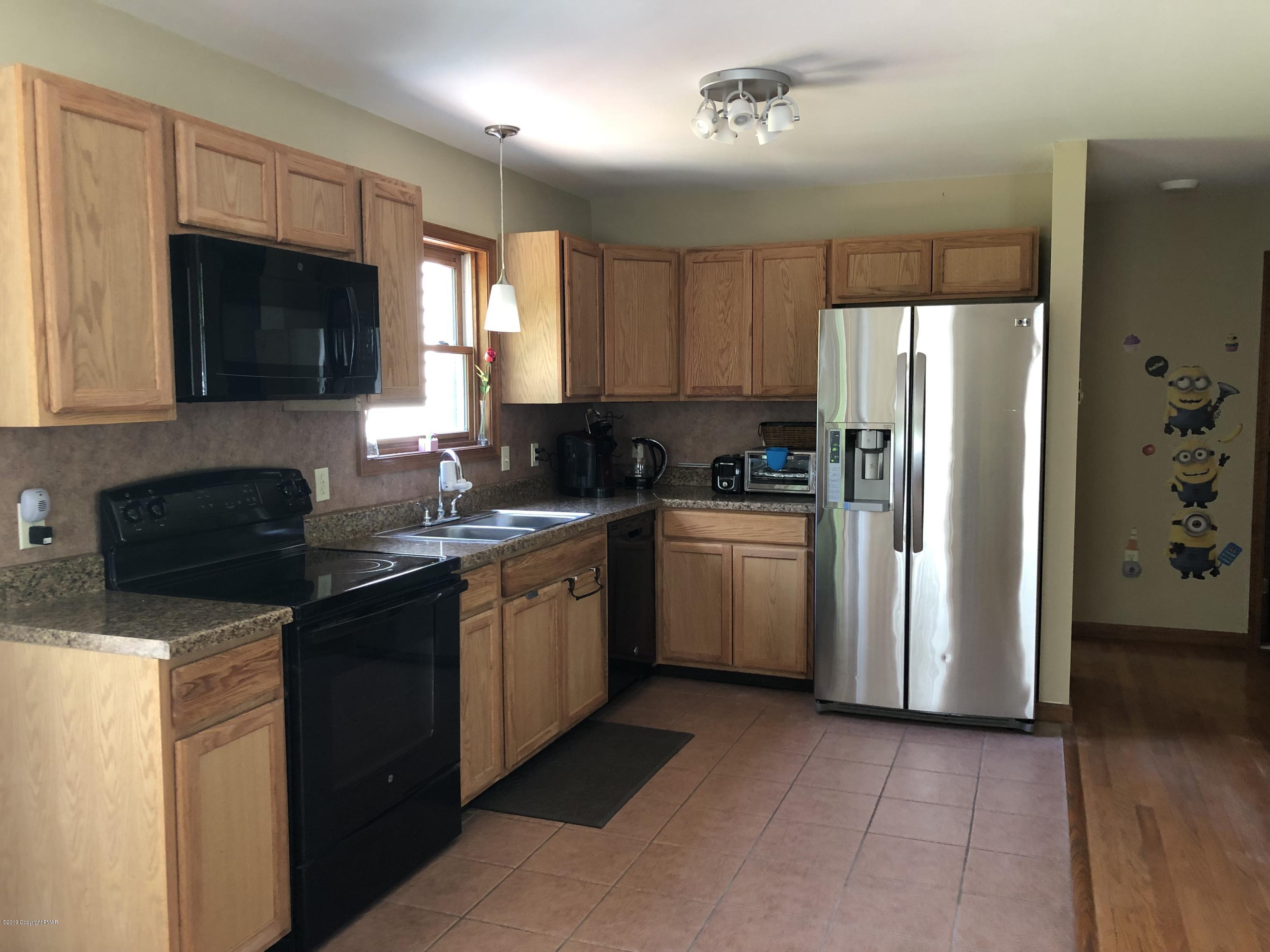 189 Gold Finch Road Bushkill, PA 18324 - Photo 10 of 23 a kitchen with a sink stove and refrigerator