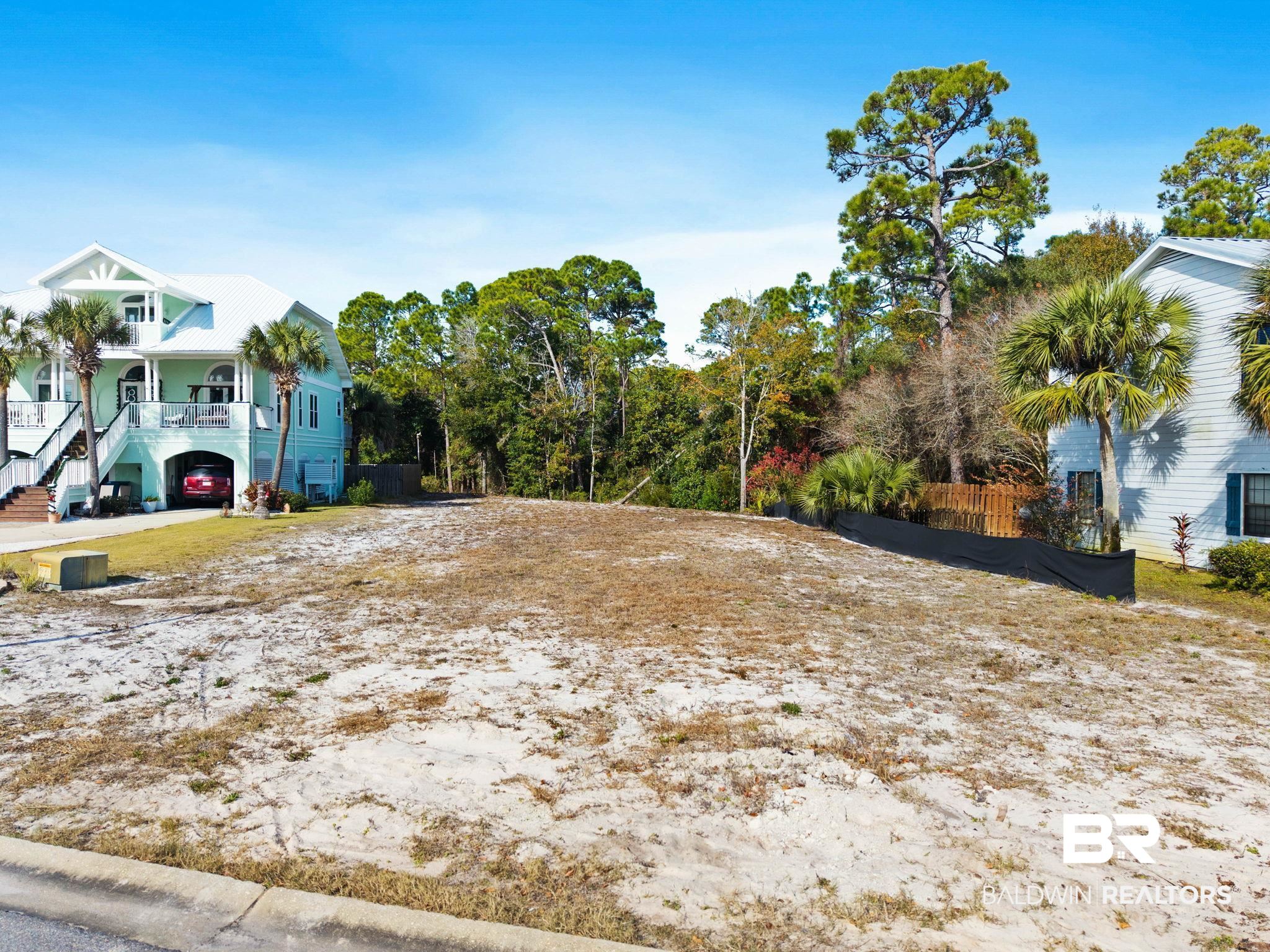 4143 Harbor Road Orange Beach, AL 36561 - Photo 8 of 33 View of yard featuring stairs and covered porch