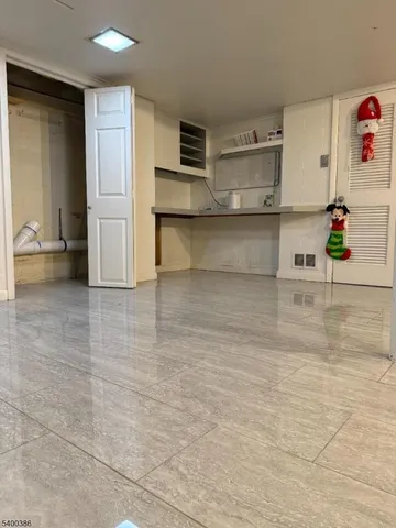 a view of kitchen with furniture and refrigerator